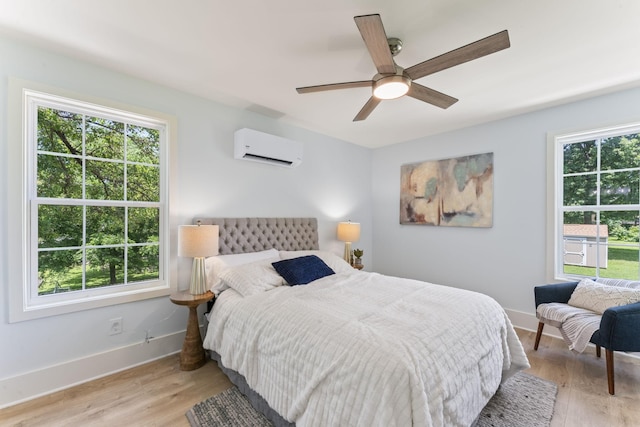 712 N 5th St, Nashville, TN 37207 - bedroom featuring a wall unit AC, multiple windows, and light wood-style floors