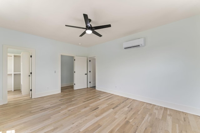 712 N 5th St, Nashville, TN 37207 - unfurnished bedroom featuring a wall mounted air conditioner, light wood-style floors, and baseboards