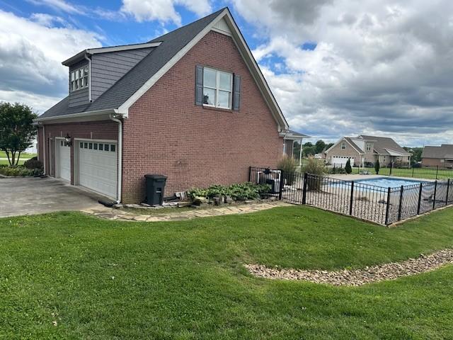 106 Rigney Rd, Manchester, TN 37355 - view of home's exterior featuring brick siding, concrete driveway, and a garage
