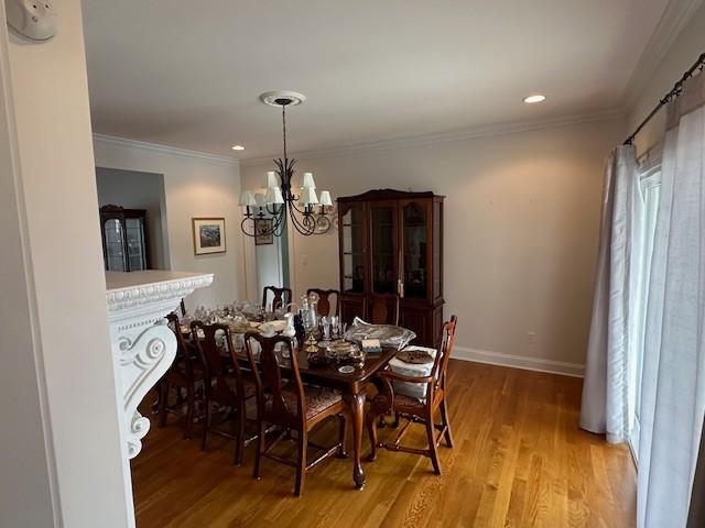 106 Rigney Rd, Manchester, TN 37355 - dining room featuring a chandelier, light wood-type flooring, recessed lighting, crown molding, and baseboards