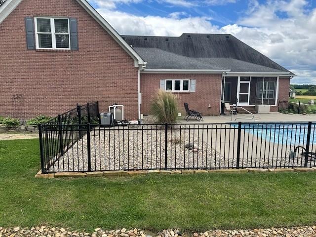 106 Rigney Rd, Manchester, TN 37355 - rear view of property with brick siding, a patio area, and a sunroom