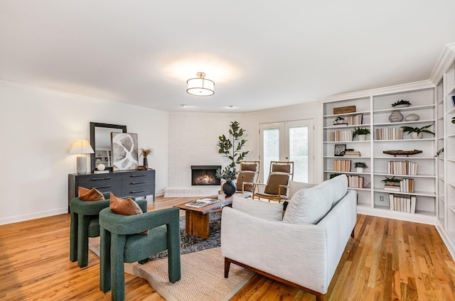109 Pebble Creek Rd, Franklin, TN 37064 - living area with light wood finished floors, a brick fireplace, crown molding, and baseboards