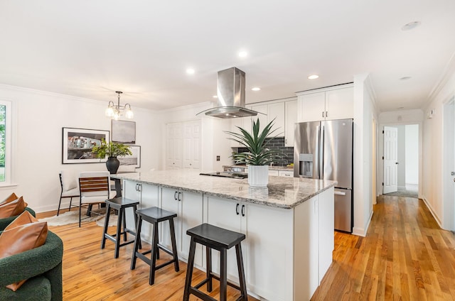 109 Pebble Creek Rd, Franklin, TN 37064 - kitchen with stainless steel fridge with ice dispenser, island exhaust hood, ornamental molding, a kitchen island, and white cabinetry