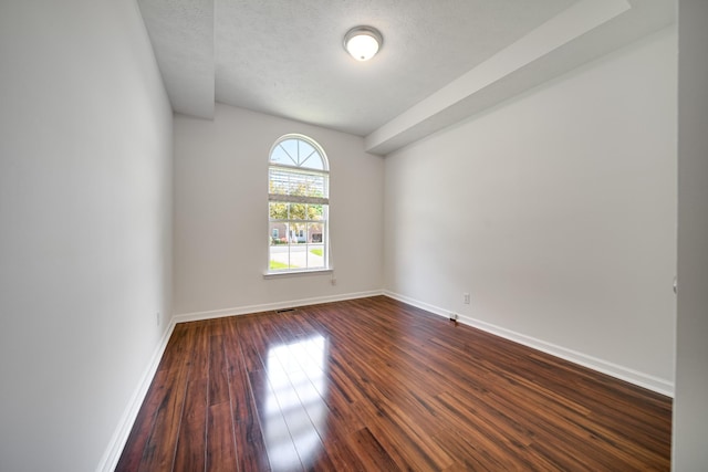 210 Apache Trl, White House, TN 37188 - spare room featuring dark wood-style floors, baseboards, and a textured ceiling