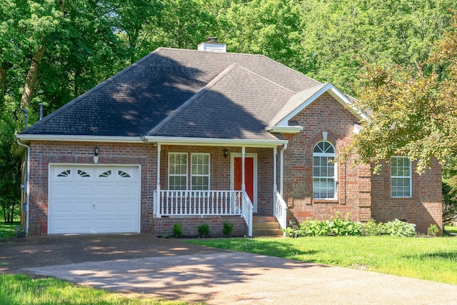 210 Apache Trl, White House, TN 37188 - traditional-style home with covered porch, a garage, asphalt driveway, a chimney, and brick siding