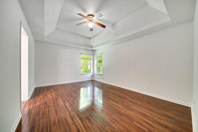 210 Apache Trl, White House, TN 37188 - unfurnished room with a raised ceiling, ceiling fan, baseboards, and dark wood-style floors