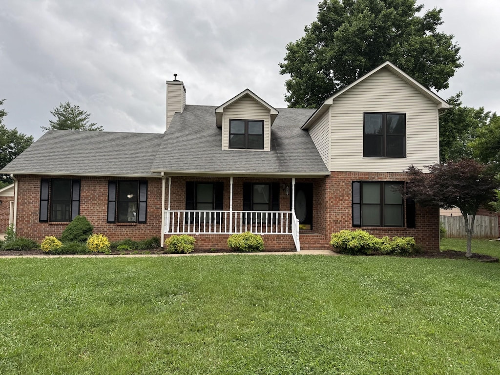 407 Haynes Haven Ln, Murfreesboro, TN 37129 - traditional-style house featuring brick siding, covered porch, a chimney, and a shingled roof