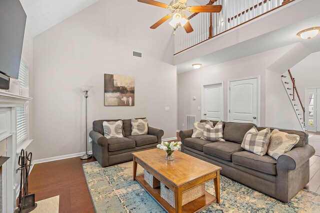 2034 Lincoln Rd, Spring Hill, TN 37174 - living area with high vaulted ceiling, a ceiling fan, baseboards, stairs, and wood finished floors
