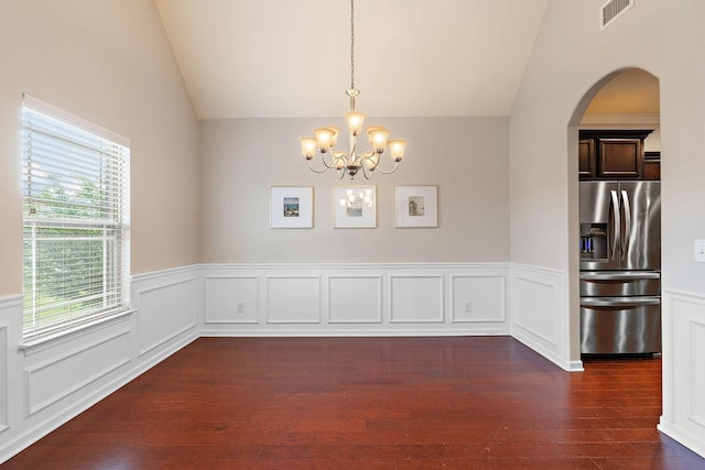 2034 Lincoln Rd, Spring Hill, TN 37174 - unfurnished dining area featuring lofted ceiling, dark wood-type flooring, a chandelier, arched walkways, and wainscoting