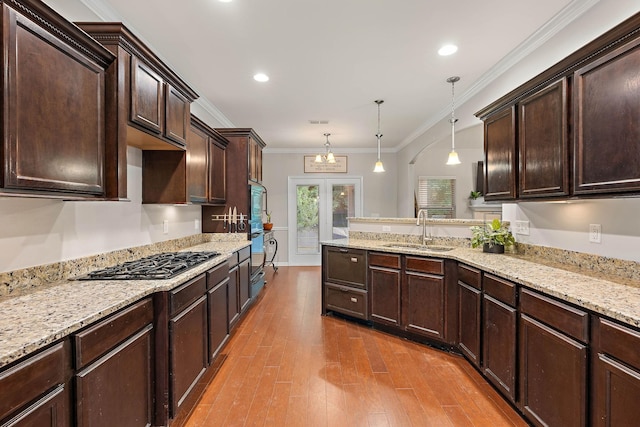 2034 Lincoln Rd, Spring Hill, TN 37174 - kitchen with a sink, gas stovetop, dark brown cabinets, dark wood-style floors, and a peninsula