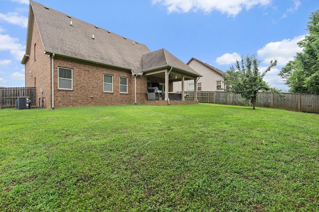 2034 Lincoln Rd, Spring Hill, TN 37174 - back of house featuring central AC unit, brick siding, and a shingled roof