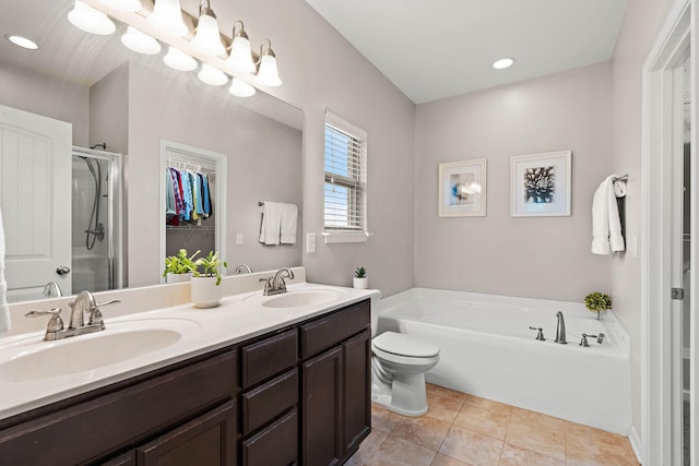 2034 Lincoln Rd, Spring Hill, TN 37174 - bathroom with a garden tub, double vanity, a shower stall, a spacious closet, and tile patterned floors