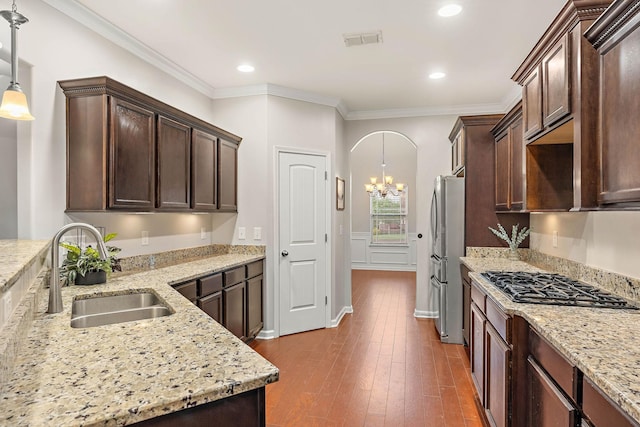 2034 Lincoln Rd, Spring Hill, TN 37174 - kitchen featuring freestanding refrigerator, a sink, gas stovetop, dark brown cabinetry, and ornamental molding