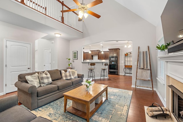 2034 Lincoln Rd, Spring Hill, TN 37174 - living area with high vaulted ceiling, ceiling fan, a fireplace, dark wood-style flooring, and baseboards