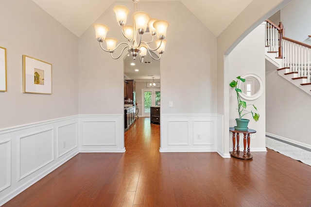 2034 Lincoln Rd, Spring Hill, TN 37174 - unfurnished dining area with vaulted ceiling, a chandelier, stairs, wainscoting, and dark wood-style flooring