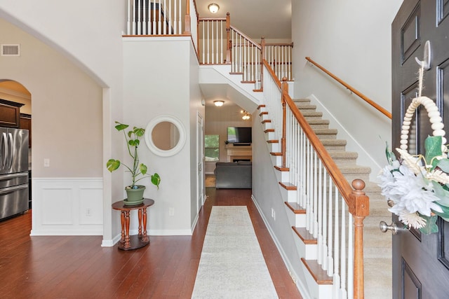 2034 Lincoln Rd, Spring Hill, TN 37174 - foyer with arched walkways, stairway, a high ceiling, and dark wood-type flooring