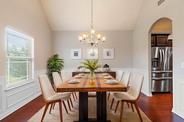 2034 Lincoln Rd, Spring Hill, TN 37174 - dining room with lofted ceiling, dark wood finished floors, a chandelier, arched walkways, and wainscoting