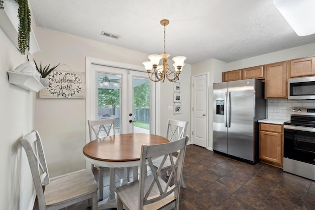 4641 Cather Ct, Nashville, TN 37214 - dining area featuring a chandelier, french doors, dark stone finish flooring, and a textured ceiling