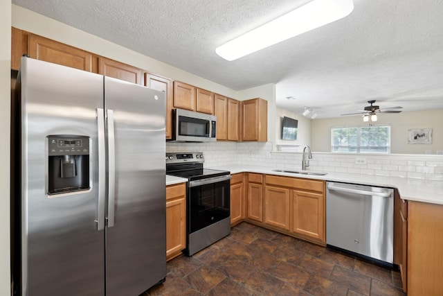 4641 Cather Ct, Nashville, TN 37214 - kitchen featuring appliances with stainless steel finishes, a sink, tasteful backsplash, stone finish flooring, and light countertops