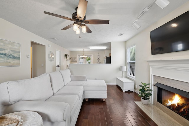4641 Cather Ct, Nashville, TN 37214 - living area with dark wood-style flooring, a fireplace with flush hearth, a chandelier, a ceiling fan, and baseboards
