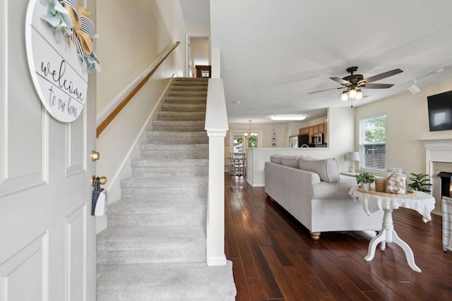 4641 Cather Ct, Nashville, TN 37214 - living area with a fireplace, ceiling fan, dark wood finished floors, track lighting, and stairway