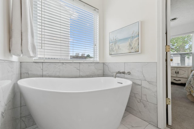 4641 Cather Ct, Nashville, TN 37214 - full bath with tile walls, marble finish flooring, ensuite bathroom, a soaking tub, and a wainscoted wall
