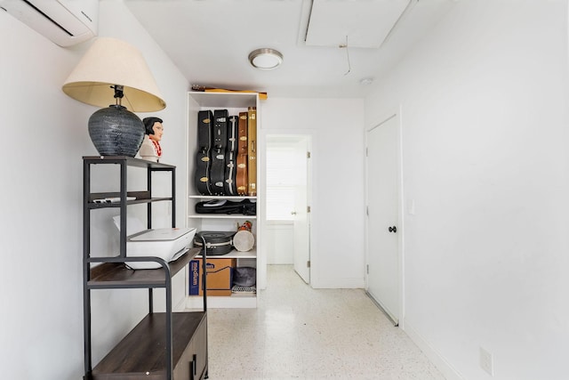 2101 Dearborn Dr, Nashville, TN 37214 - corridor with an AC wall unit, attic access, speckle patterned floor, and baseboards