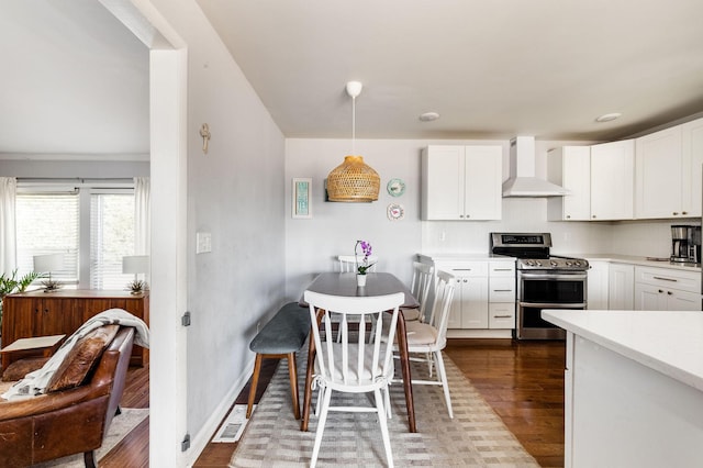 2101 Dearborn Dr, Nashville, TN 37214 - kitchen with range with two ovens, wall chimney range hood, dark wood-type flooring, light countertops, and white cabinets