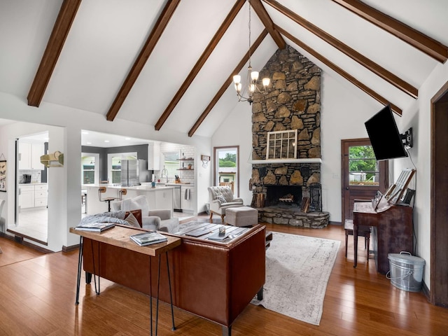 2521 Greens Mill Rd, Columbia, TN 38401 - living area featuring high vaulted ceiling, beamed ceiling, wood finished floors, a chandelier, and a fireplace