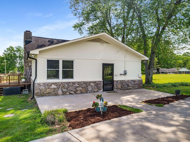 2521 Greens Mill Rd, Columbia, TN 38401 - rear view of property with a chimney, stone siding, a yard, and a deck