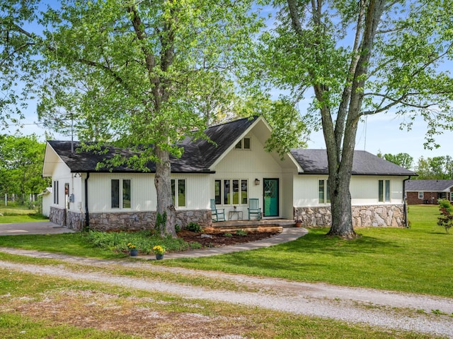 2521 Greens Mill Rd, Columbia, TN 38401 - view of front of house featuring stone siding, a front yard, and a shingled roof