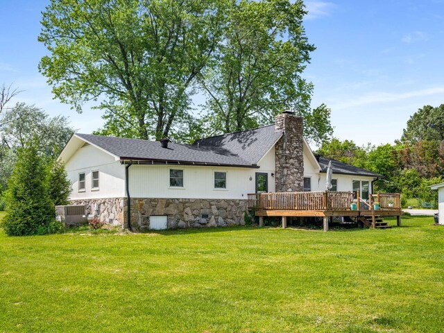 2521 Greens Mill Rd, Columbia, TN 38401 - back of property with stone siding, a yard, a chimney, a wooden deck, and central AC unit