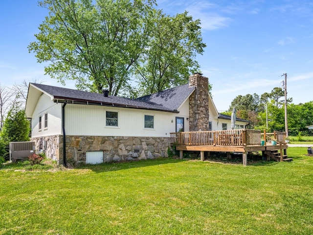 2521 Greens Mill Rd, Columbia, TN 38401 - rear view of house featuring a wooden deck, a yard, stone siding, a chimney, and cooling unit