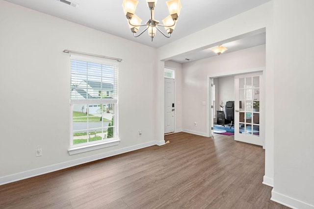 8061 Warbler Way, Brentwood, TN 37027 - unfurnished room featuring a chandelier, wood finished floors, and healthy amount of natural light