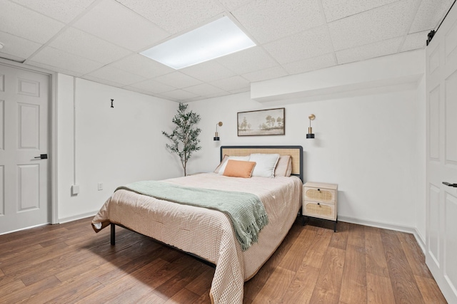 301 Tyler Dr, Hermitage, TN 37076 - bedroom featuring a drop ceiling, wood-type flooring, and baseboards