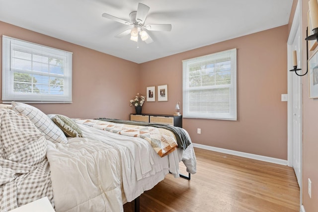 301 Tyler Dr, Hermitage, TN 37076 - bedroom featuring multiple windows, light wood-style floors, baseboards, and ceiling fan