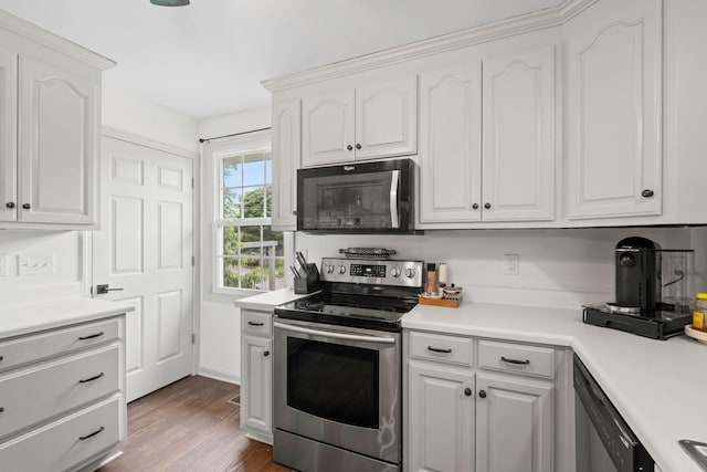 301 Tyler Dr, Hermitage, TN 37076 - kitchen with appliances with stainless steel finishes, white cabinetry, light countertops, and dark wood-type flooring