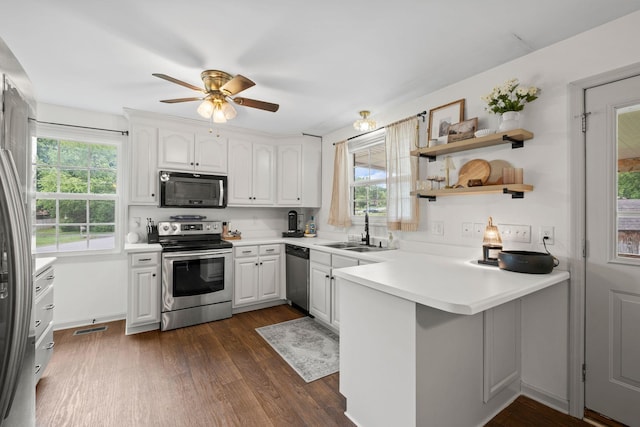 301 Tyler Dr, Hermitage, TN 37076 - kitchen with stainless steel appliances, a sink, a peninsula, a ceiling fan, and dark wood-style floors