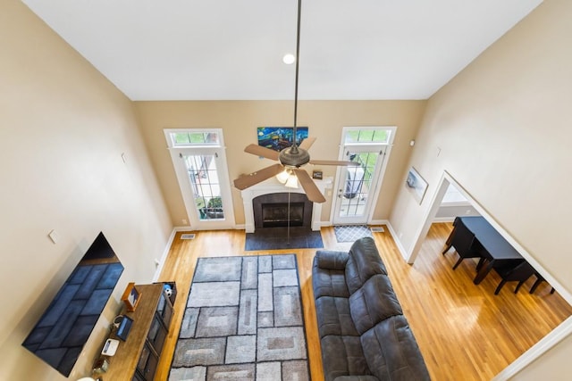 2931 Runnymeade Dr, Murfreesboro, TN 37127 - living area with wood finished floors, baseboards, ceiling fan, and a fireplace with flush hearth