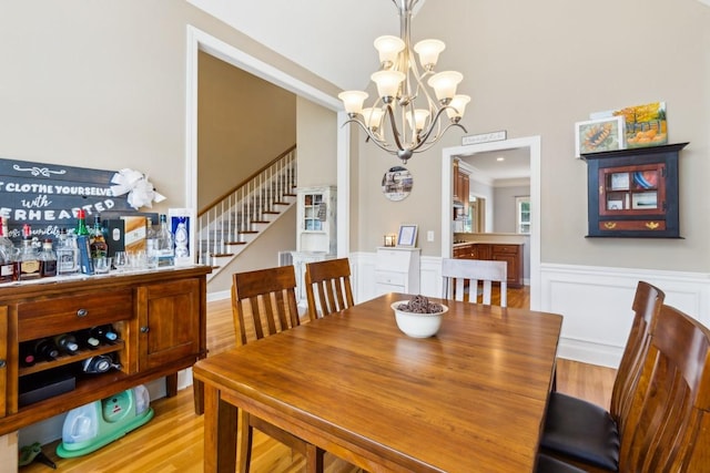 2931 Runnymeade Dr, Murfreesboro, TN 37127 - dining area featuring light wood-style floors, stairway, a chandelier, and a wainscoted wall