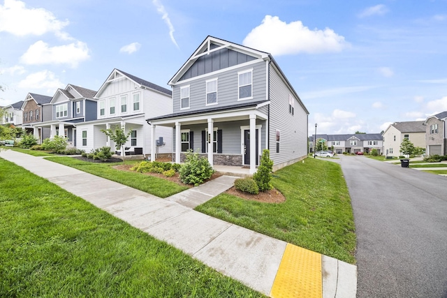 700 Taylor Bend Rd, Columbia, TN 38401 - townhome / multi-family property featuring board and batten siding, a residential view, a porch, a front yard, and stone siding