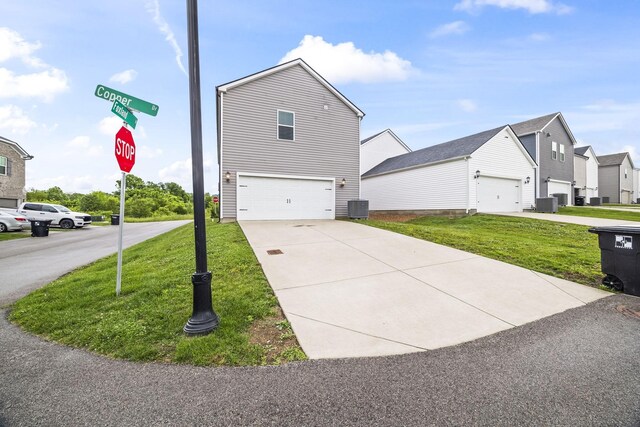 700 Taylor Bend Rd, Columbia, TN 38401 - view of property exterior featuring central AC, a yard, a residential view, and concrete driveway