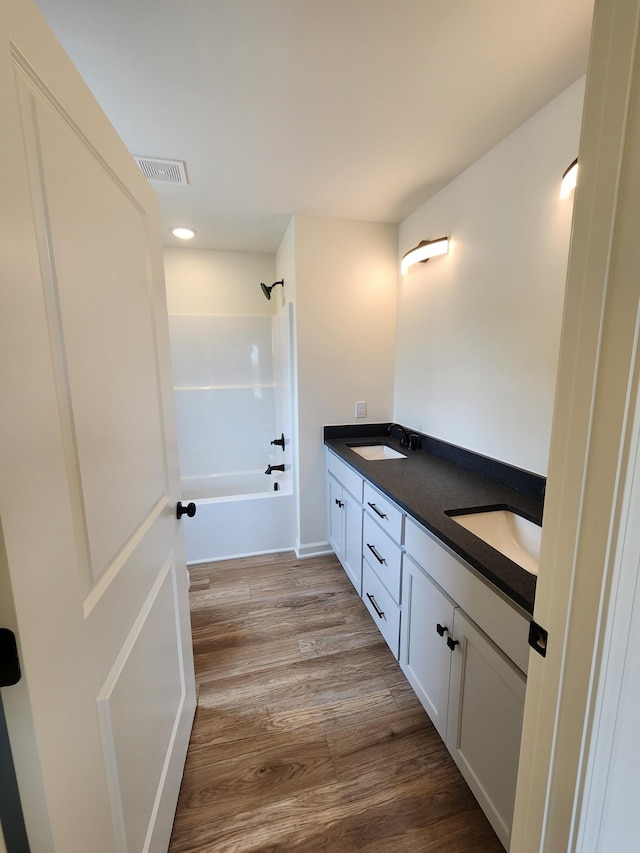 524 Pleasant Hill Rd, Lafayette, TN 37083 - bathroom featuring double vanity, wood finished floors, shower / bath combination, and recessed lighting
