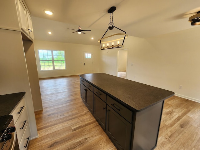 524 Pleasant Hill Rd, Lafayette, TN 37083 - kitchen featuring dark countertops, ceiling fan, gas range, open floor plan, and a center island