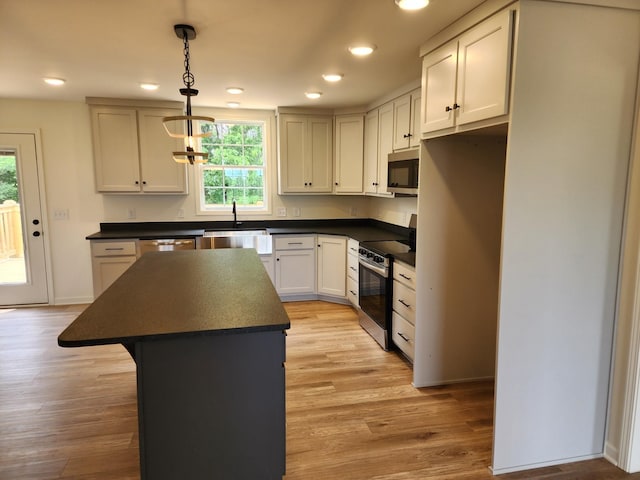 524 Pleasant Hill Rd, Lafayette, TN 37083 - kitchen with stainless steel appliances, dark countertops, a center island, light wood-style flooring, and recessed lighting
