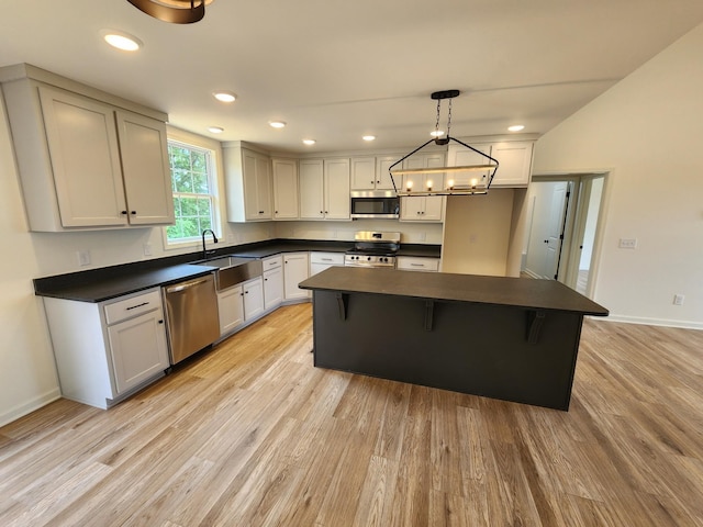524 Pleasant Hill Rd, Lafayette, TN 37083 - kitchen with stainless steel appliances, dark countertops, a sink, light wood-type flooring, and recessed lighting