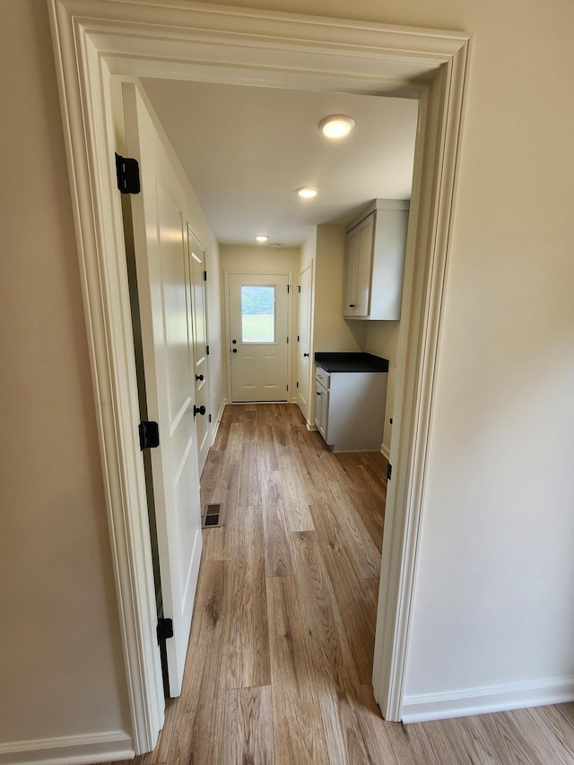 524 Pleasant Hill Rd, Lafayette, TN 37083 - laundry room featuring wood finished floors and baseboards