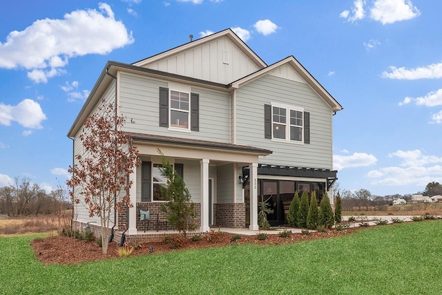 188 Millbrook Dr, Spring Hill, TN 37174 - view of front of home featuring covered porch, board and batten siding, a front yard, and brick siding