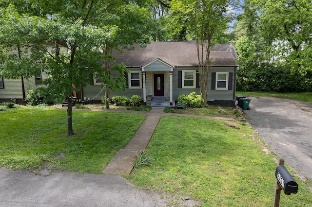 2401 Vaulx Ln, Nashville, TN 37204 - view of front of property featuring roof with shingles, a front yard, and asphalt driveway