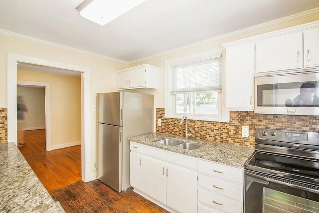 2401 Vaulx Ln, Nashville, TN 37204 - kitchen with black electric range, stainless steel microwave, a sink, freestanding refrigerator, and ornamental molding